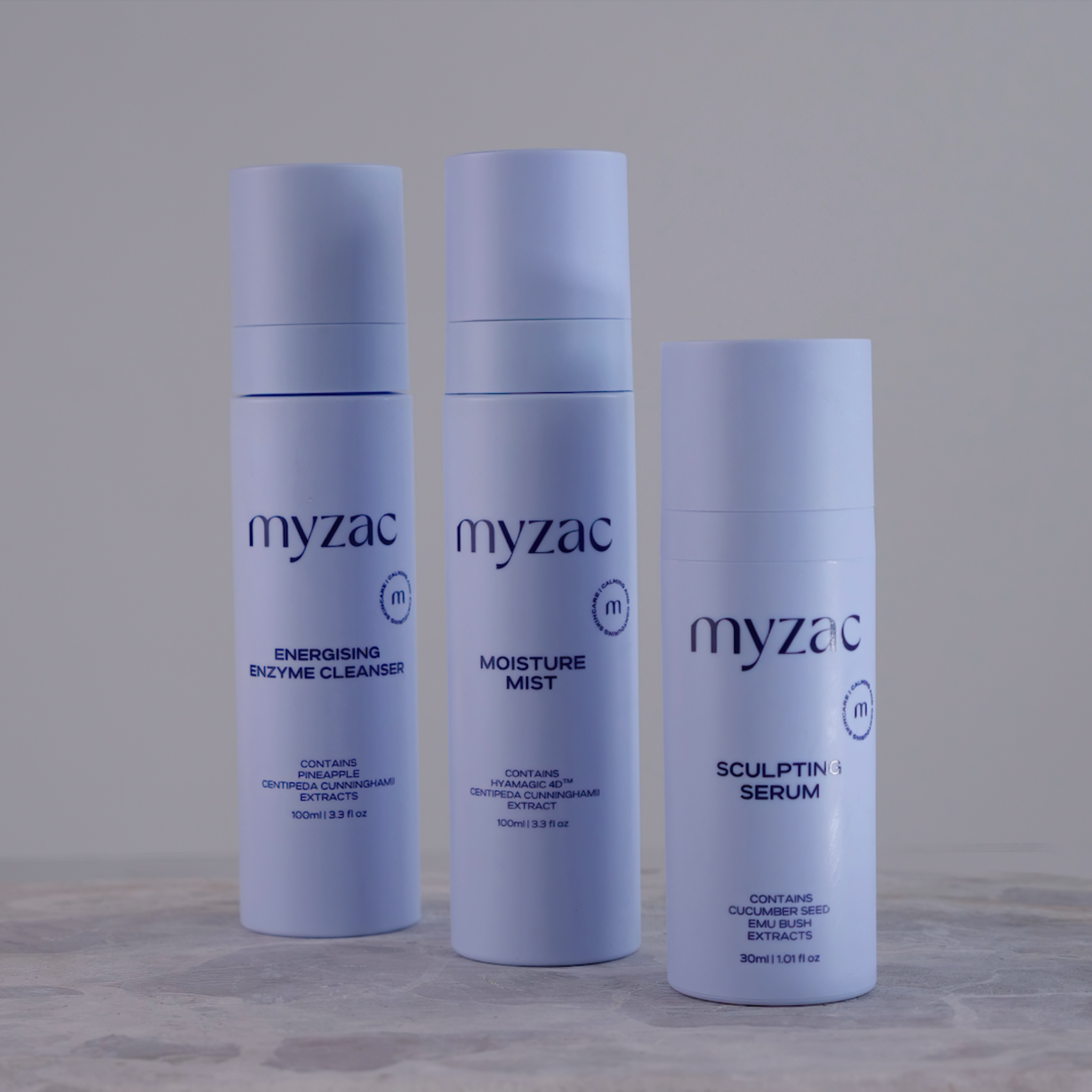 Full Ritual Bundle lineup showing cleanser, mist, and serum with open pump, ready for use.