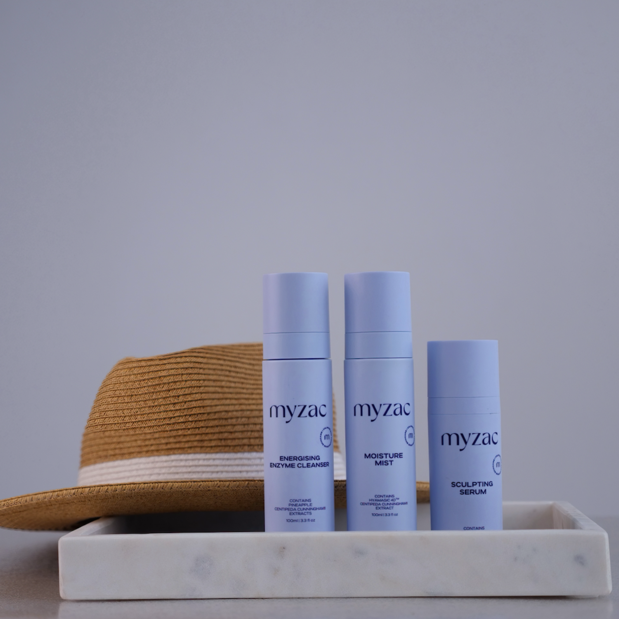 Full Ritual Bundle displayed with a summer hat, highlighting travel-friendly skincare essentials.
