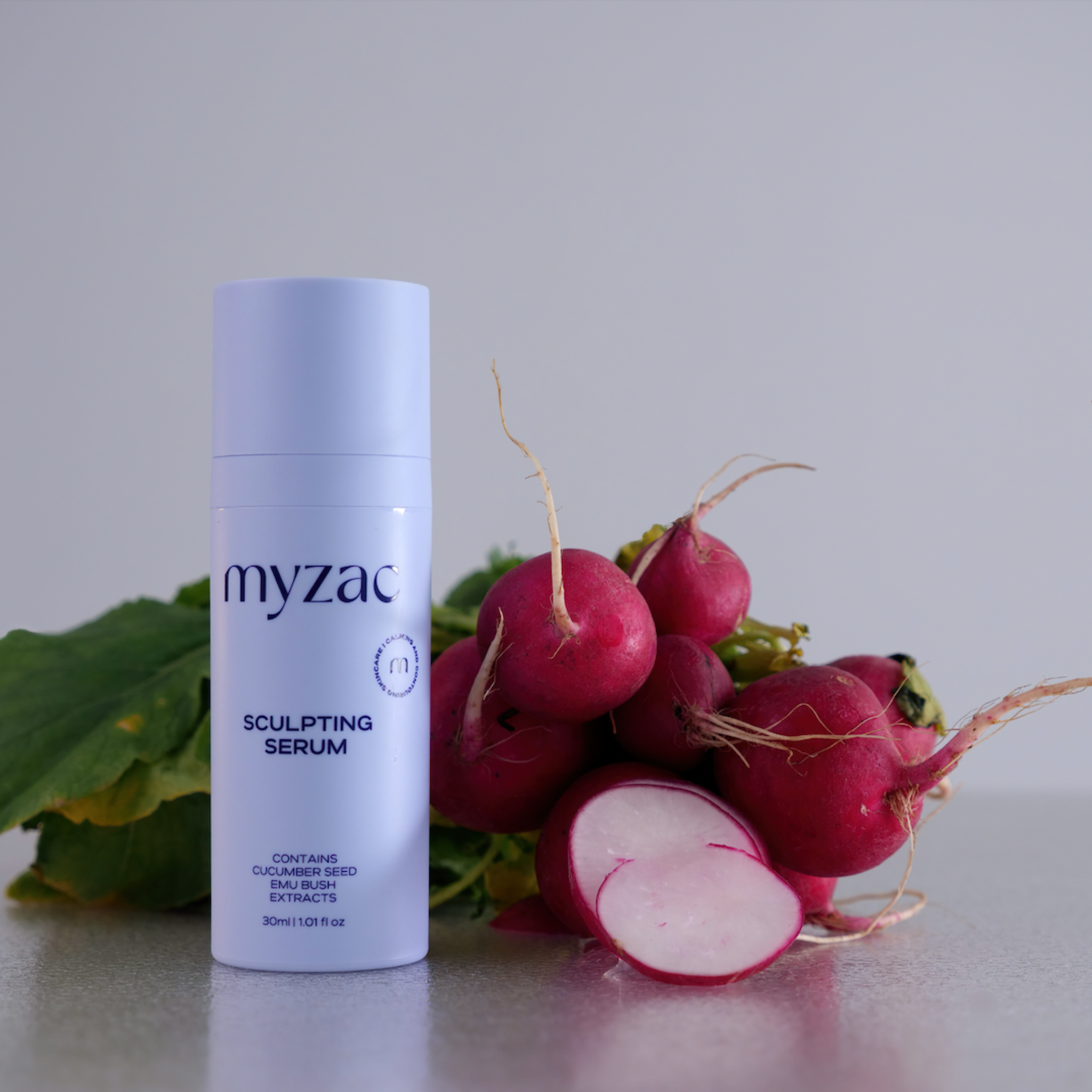 MYZAC Sculpting Serum bottle with radish, highlighting key botanical ingredient.